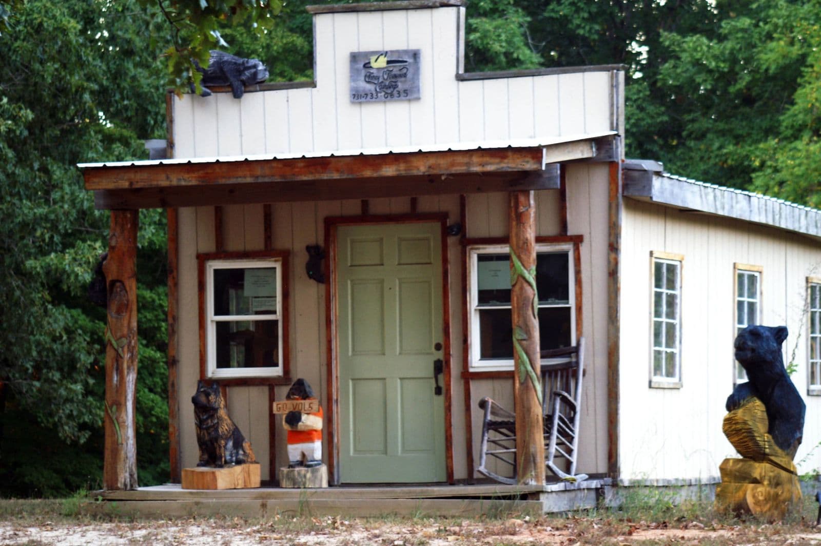 The workshop: a small western-style storefront with carved bears on the porch and roof